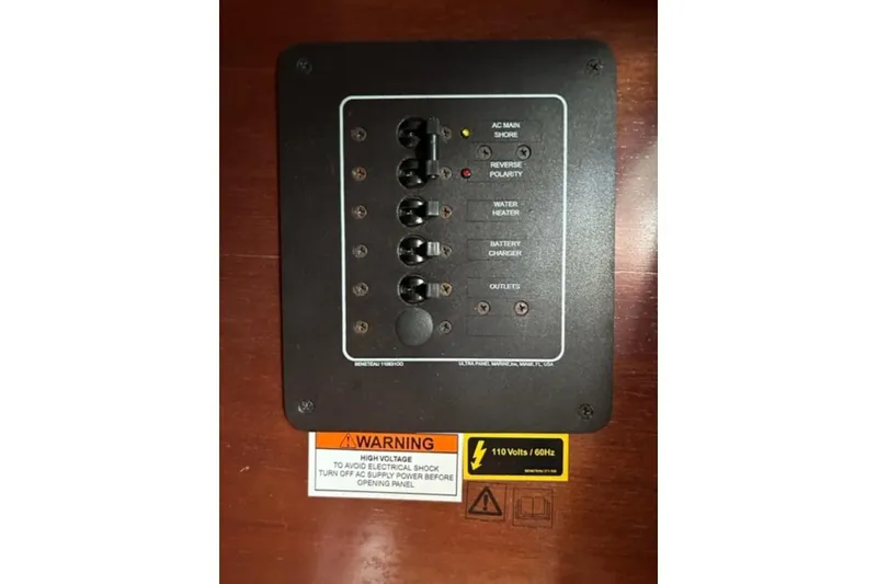 Slide: The Image of Electrical panel on a 2003 Beneteau 331 sailboat with warning labels. - 21
