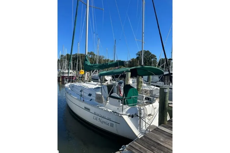 Slide: The Image of 2003 Beneteau 331 sailboat docked at marina with green canopy. - 3
