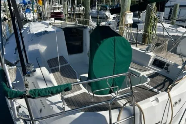 Slide: The Image of 2003 Beneteau 331 sailboat cockpit with green cover, docked at marina. - 5