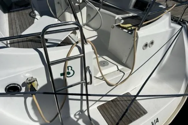 Slide: The Image of 2003 Beneteau 331 sailboat cockpit with ladder and ropes, showcasing deck details. - 7