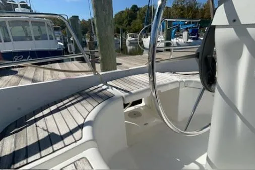 Slide: The Image of 2003 Beneteau 331 sailboat cockpit with steering wheel, docked in marina. - 8