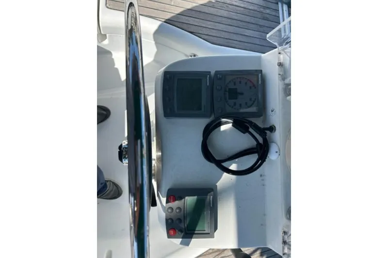 Slide: The Image of Steering wheel and instruments on a 2003 Beneteau 331 sailboat. - 9
