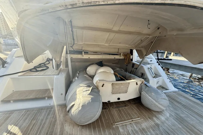 Slide: The Image of 2016 Cranchi M 44 HT yacht with open storage compartment and inflatable dinghy. - 13