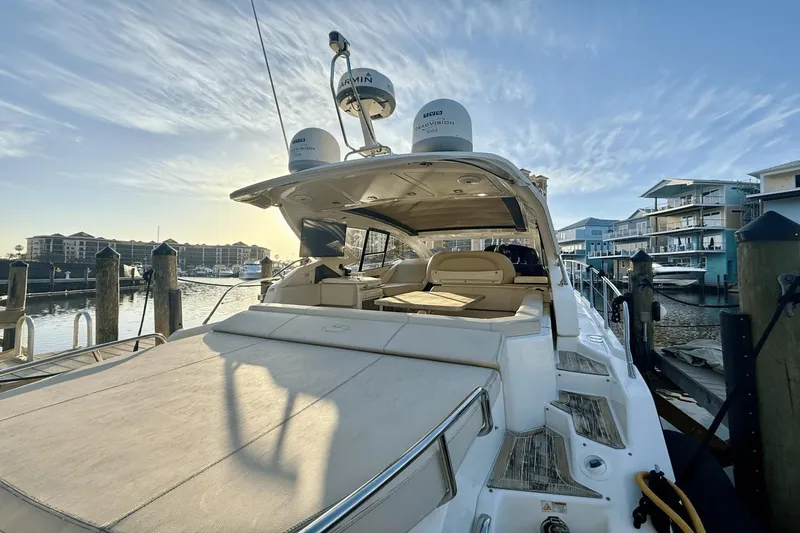 Slide: The Image of 2016 Cranchi M 44 HT yacht docked at marina, showcasing luxurious deck and seating. - 15