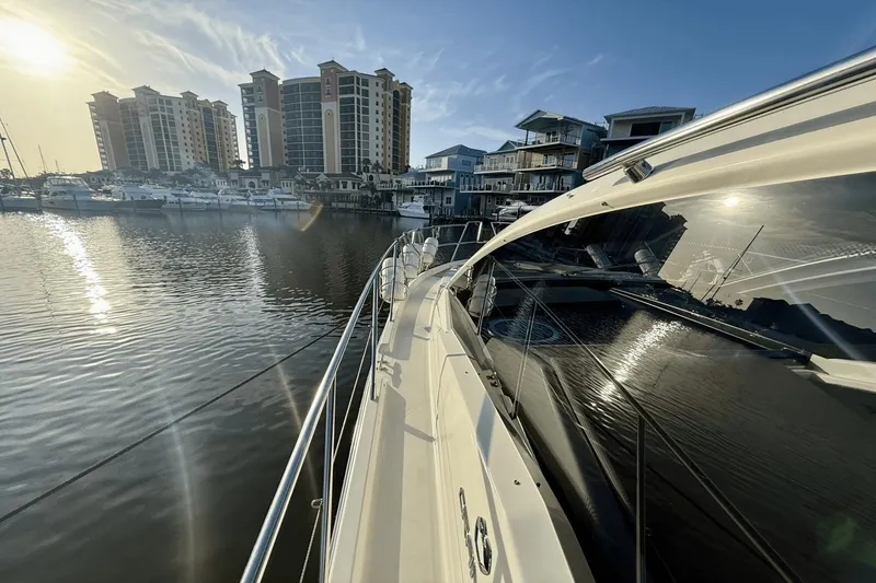 Slide: The Image of 2016 Cranchi M 44 HT yacht docked in marina with cityscape background. - 18
