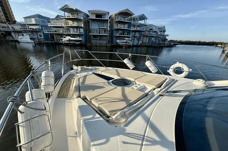 Slide: The Image of 2016 Cranchi M 44 HT yacht docked near modern waterfront homes. - 19