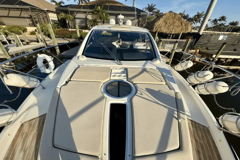 Slide: The Image of 2016 Cranchi M 44 HT yacht docked, featuring sleek design and sunbathing area. - 21