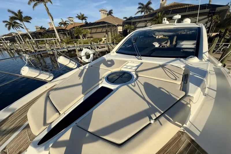 Slide: The Image of 2016 Cranchi M 44 HT yacht docked, featuring sleek design and sunbathing area. - 22