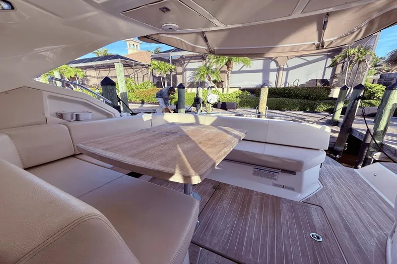 Slide: The Image of Luxurious 2016 Cranchi M 44 HT yacht interior with elegant seating and wooden table. - 28
