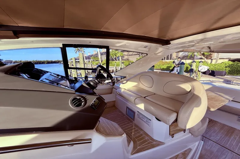Slide: The Image of Interior of 2016 Cranchi M 44 HT yacht with beige seating and steering area. - 31
