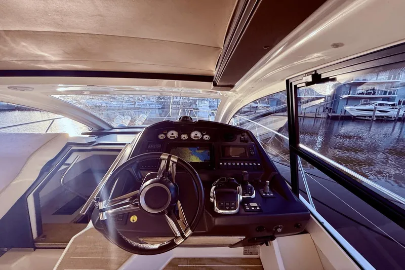 Slide: The Image of Interior view of 2016 Cranchi M 44 HT yacht cockpit with steering wheel and control panel. - 33