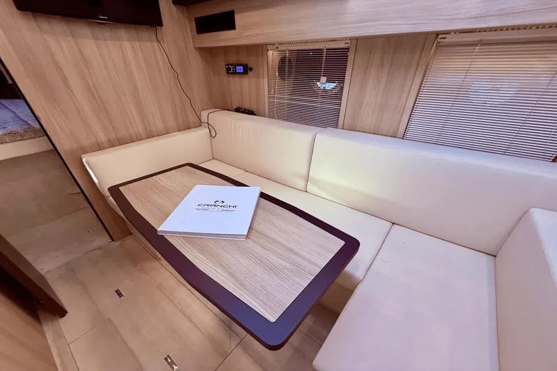 Slide: The Image of Interior of 2016 Cranchi M 44 HT yacht with beige seating and wooden table. - 39
