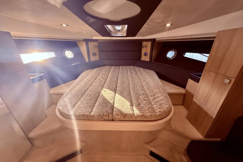 Slide: The Image of Luxurious 2016 Cranchi M 44 HT yacht cabin with elegant bedding and natural light. - 41