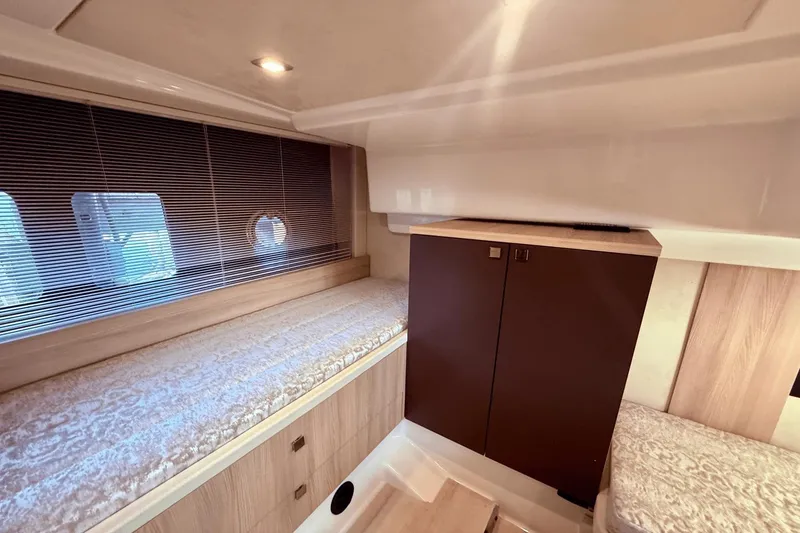 Slide: The Image of Interior cabin of 2016 Cranchi M 44 HT yacht with cozy bedding and wooden cabinetry. - 48
