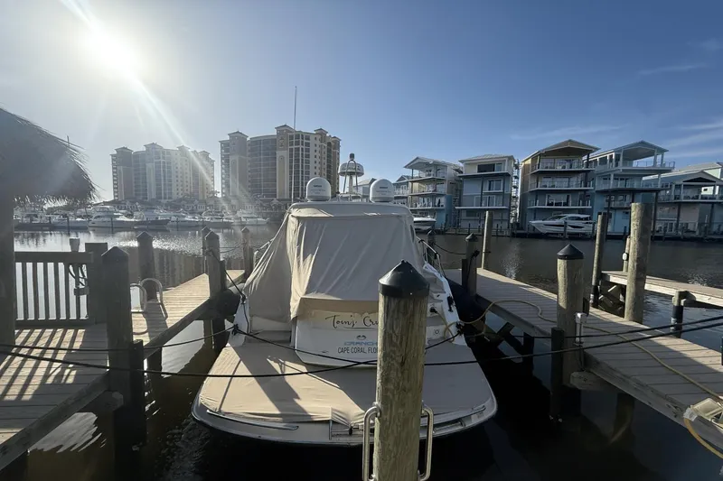 Slide: The Image of 2016 Cranchi M 44 HT yacht docked at marina, surrounded by waterfront buildings. - 57