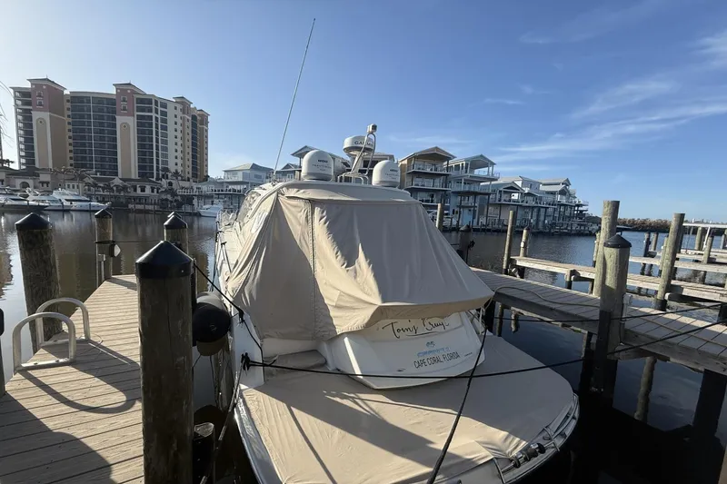 Slide: The Image of 2016 Cranchi M 44 HT yacht docked at marina with waterfront buildings. - 58