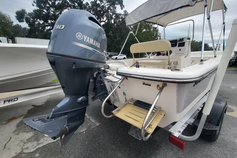 Slide: The Image of 2018 Sundance B18CCR boat with Yamaha 90 outboard motor, parked on trailer. - 11
