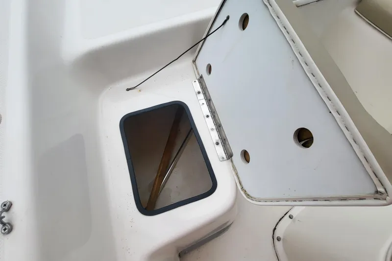 Slide: The Image of 2018 Sundance B18CCR boat compartment with open hatch and storage area. - 5
