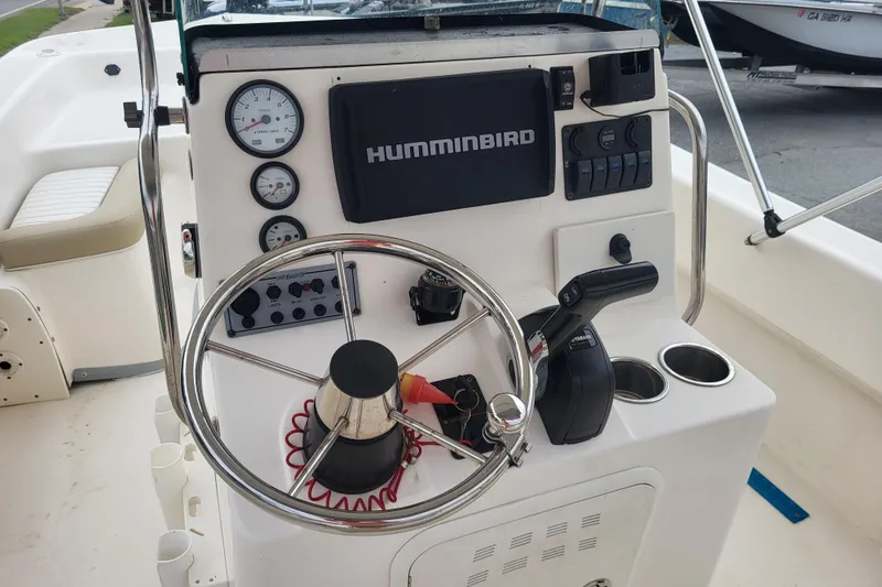 Slide: The Image of Control panel of 2018 Sundance B18CCR boat with steering wheel and Humminbird display. - 7