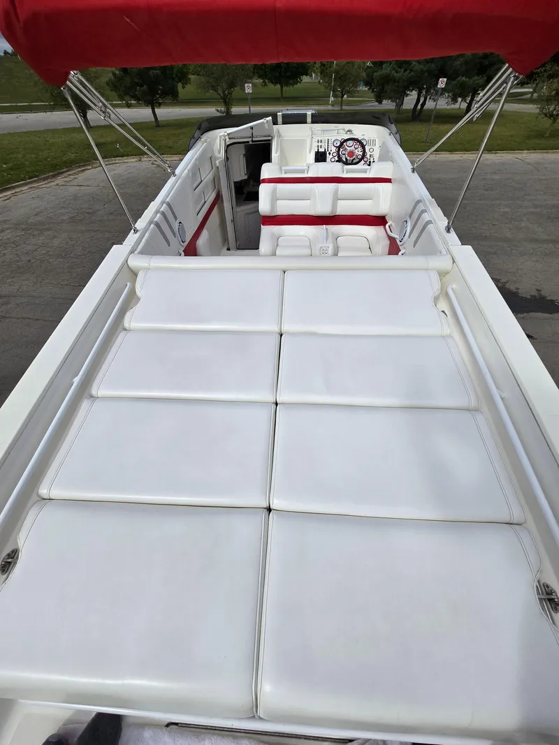 Slide: The Image of 1995 Fountain 38 Sport Cruiser with white seating and red canopy. - 21