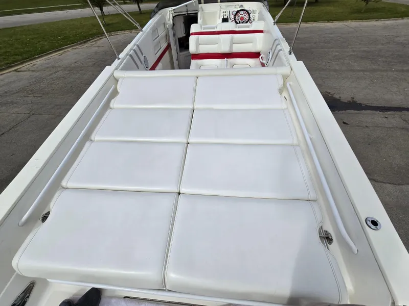 Slide: The Image of 1995 Fountain 38 Sport Cruiser with white seating and red accents, docked outdoors. - 22