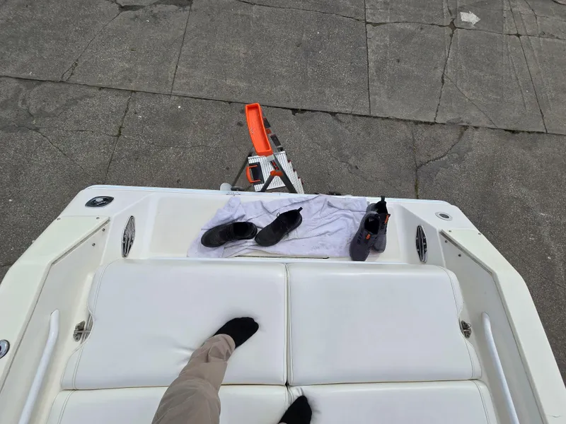 Slide: The Image of 1995 Fountain 38 Sport Cruiser deck with shoes and towel. - 23