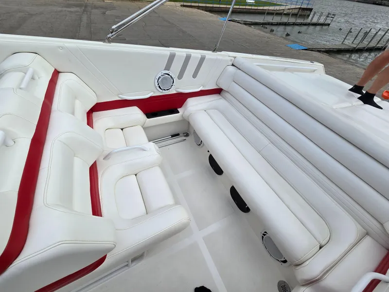 Slide: The Image of 1995 Fountain 38 Sport Cruiser interior with white and red seating, dockside view. - 26
