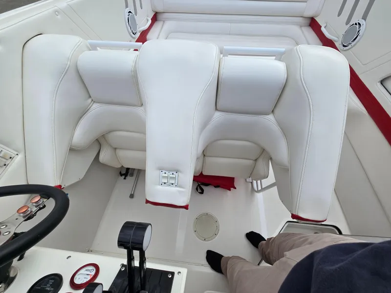 Slide: The Image of Interior of 1995 Fountain 38 Sport Cruiser with white seating and control panel. - 28