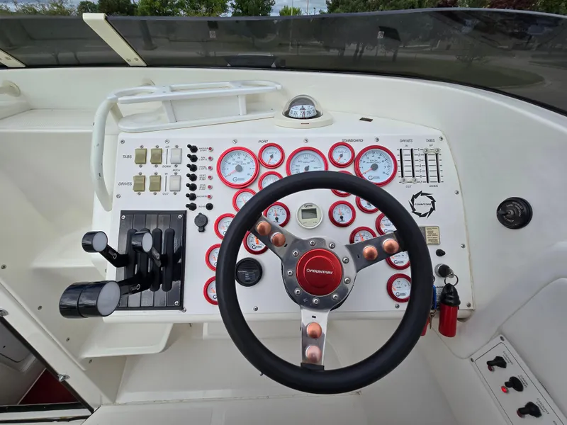 Slide: The Image of 1995 Fountain 38 Sport Cruiser dashboard with steering wheel and control panel. - 29
