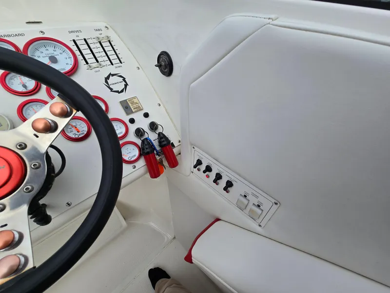 Slide: The Image of 1995 Fountain 38 Sport Cruiser dashboard with gauges and controls. - 32