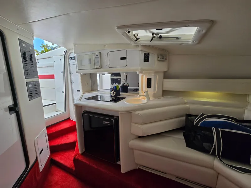 Slide: The Image of Interior of 1995 Fountain 38 Sport Cruiser with kitchenette and seating area. - 37