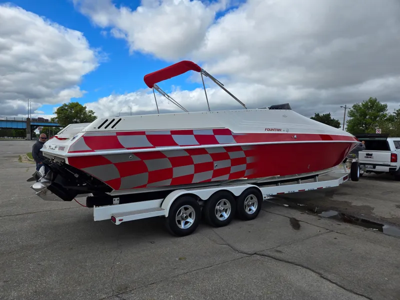 Slide: The Image of 1995 Fountain 38 Sport Cruiser with red and silver design on a trailer. - 4