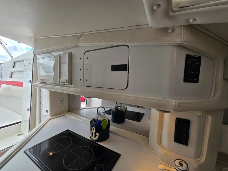 Slide: The Image of Interior of 1995 Fountain 38 Sport Cruiser with modern kitchen amenities. - 40