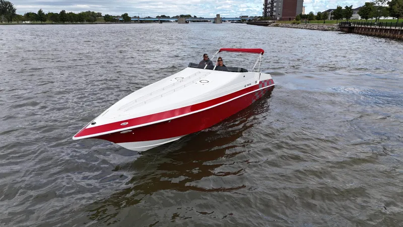 Slide: The Image of 1995 Fountain 38 Sport Cruiser boat on a river with red and white design. - 43