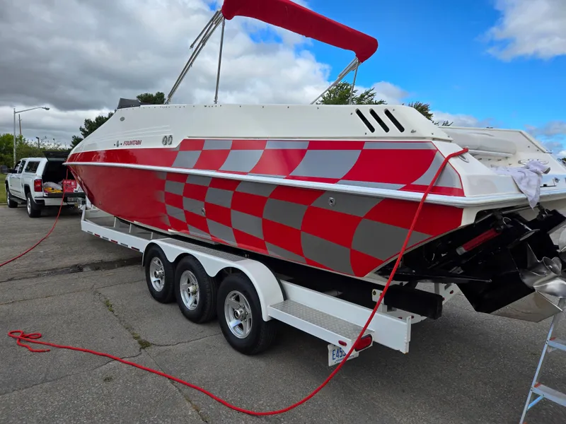Slide: The Image of 1995 Fountain 38 Sport Cruiser with red checkered design on trailer. - 7