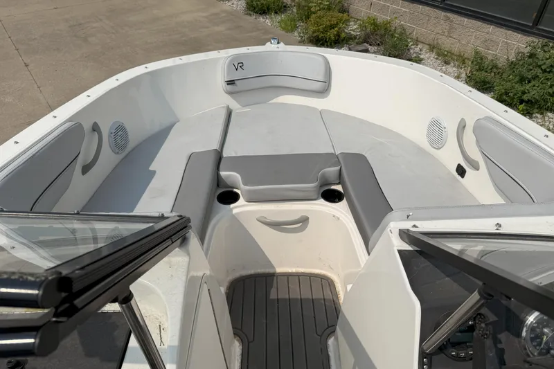 Slide: The Image of 2022 Bayliner VR4 Bowrider I/O interior with gray seating and cup holders. - 10