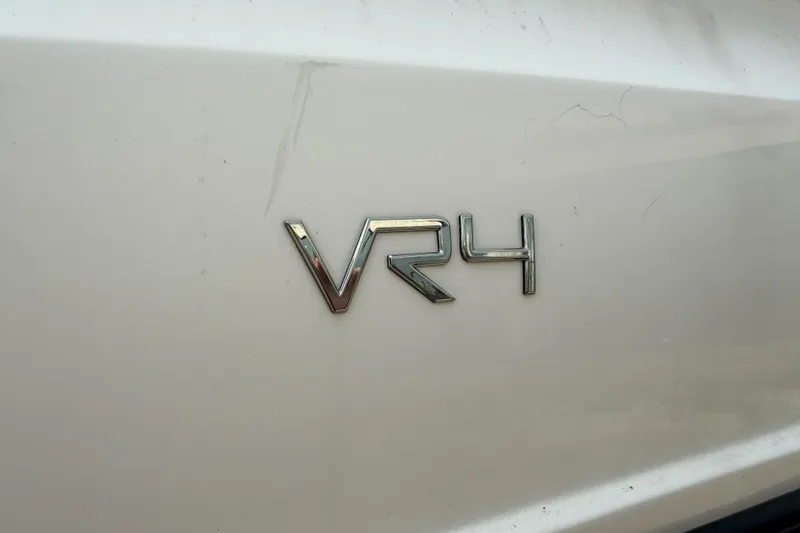 Slide: The Image of 2022 Bayliner VR4 Bowrider I/O emblem on white surface. - 12