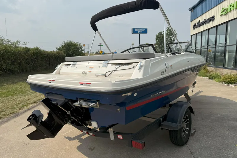Slide: The Image of 2022 Bayliner VR4 Bowrider I/O boat on trailer, parked outside dealership. - 4