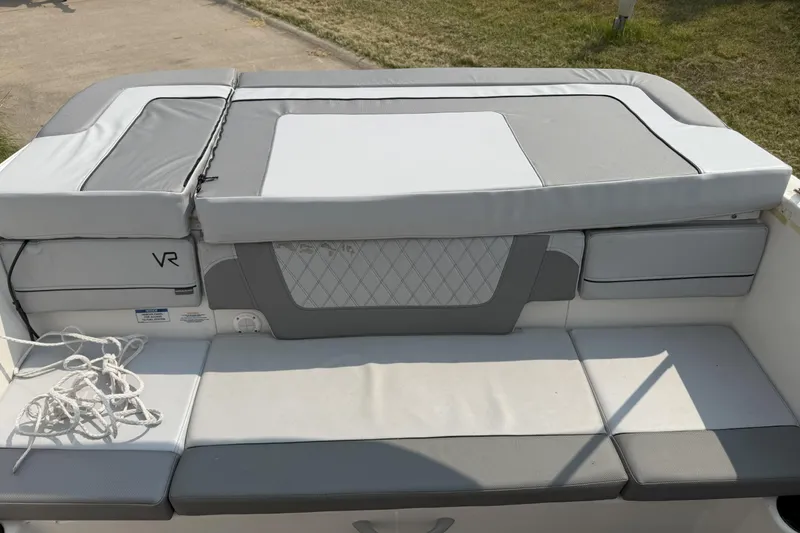 Slide: The Image of 2022 Bayliner VR4 Bowrider I/O boat interior with cushioned seating and rope. - 7