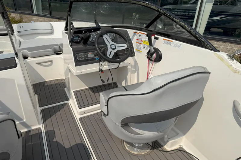 Slide: The Image of 2022 Bayliner VR4 Bowrider I/O interior with steering wheel and seating. - 8