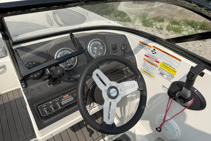 Slide: The Image of 2022 Bayliner VR4 Bowrider I/O dashboard with steering wheel and control panel. - 9