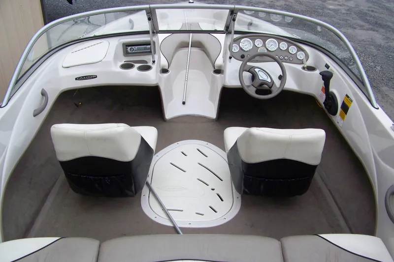 Slide: The Image of 2005 Tahoe Q4 I/O boat interior with steering wheel and seating arrangement. - 2
