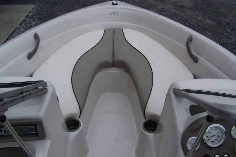 Slide: The Image of 2005 Tahoe Q4 I/O boat interior with white seating and dashboard gauges. - 5