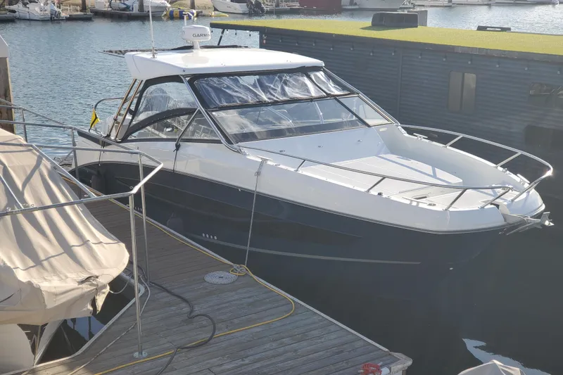 Slide: The Image of 2021 Beneteau Flyer 10 docked at marina, sleek design, modern features, and spacious deck. - 0