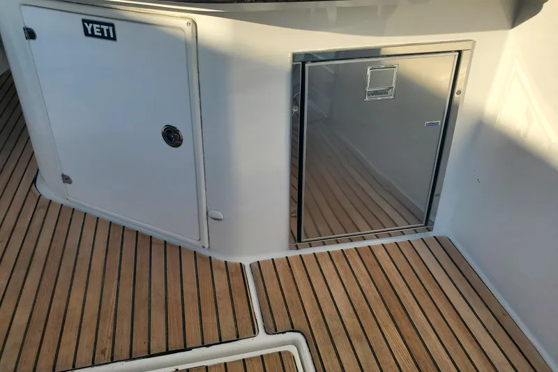 Slide: The Image of Teak deck and storage on 2021 Beneteau Flyer 10 boat, featuring Yeti cooler. - 11