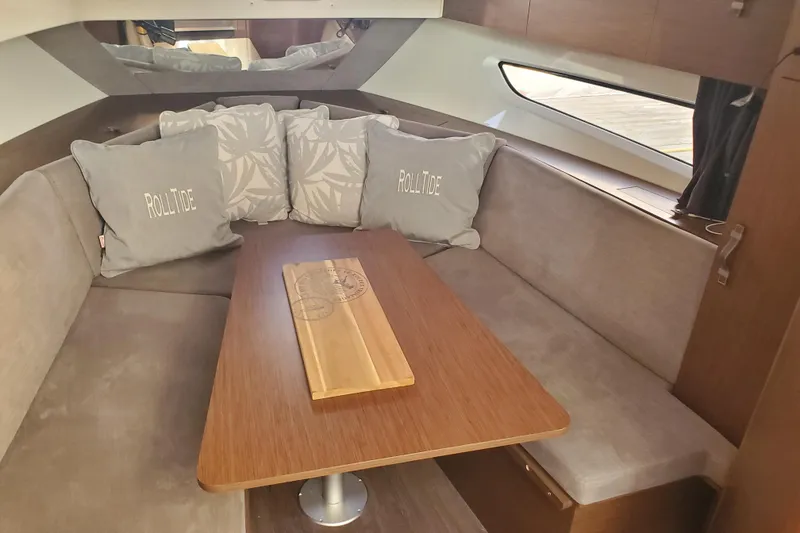 Slide: The Image of Interior of 2021 Beneteau Flyer 10 with cozy seating and decorative pillows. - 14