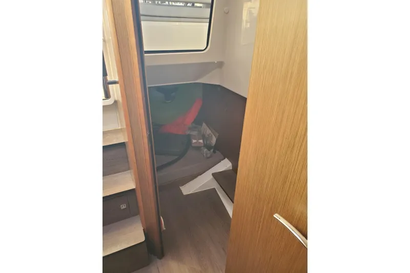 Slide: The Image of Interior cabin view of 2021 Beneteau Flyer 10 boat, featuring wooden finishes and compact design. - 15