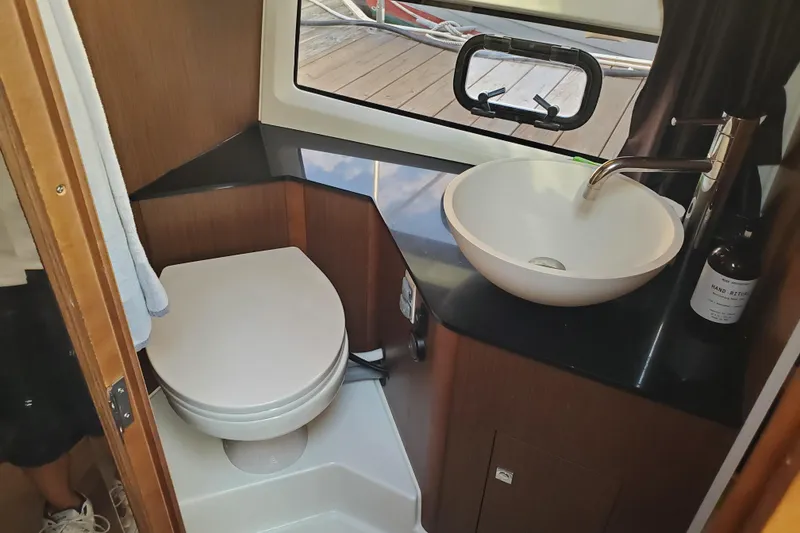 Slide: The Image of Modern bathroom in 2021 Beneteau Flyer 10 boat with toilet and sink. - 16