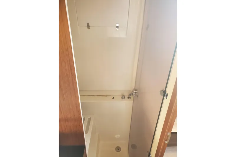 Slide: The Image of Interior view of 2021 Beneteau Flyer 10 bathroom with shower and wooden accents. - 17