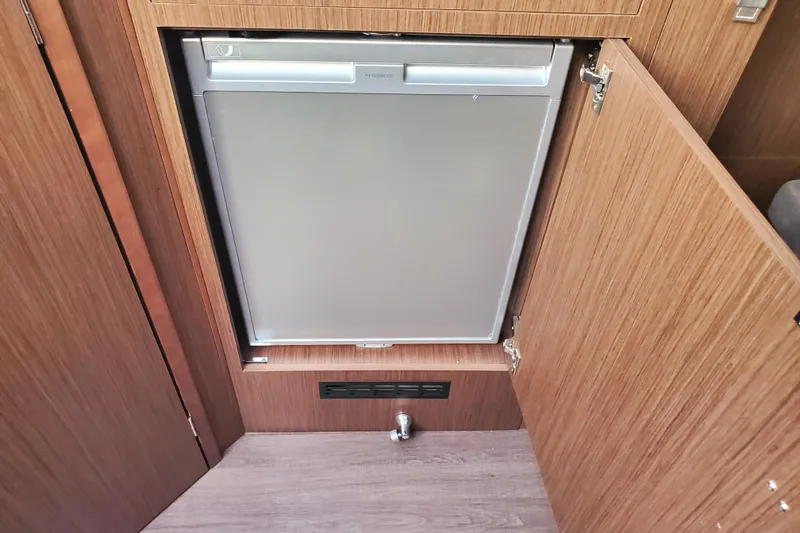 Slide: The Image of 2021 Beneteau Flyer 10 interior with built-in Dometic refrigerator. - 18